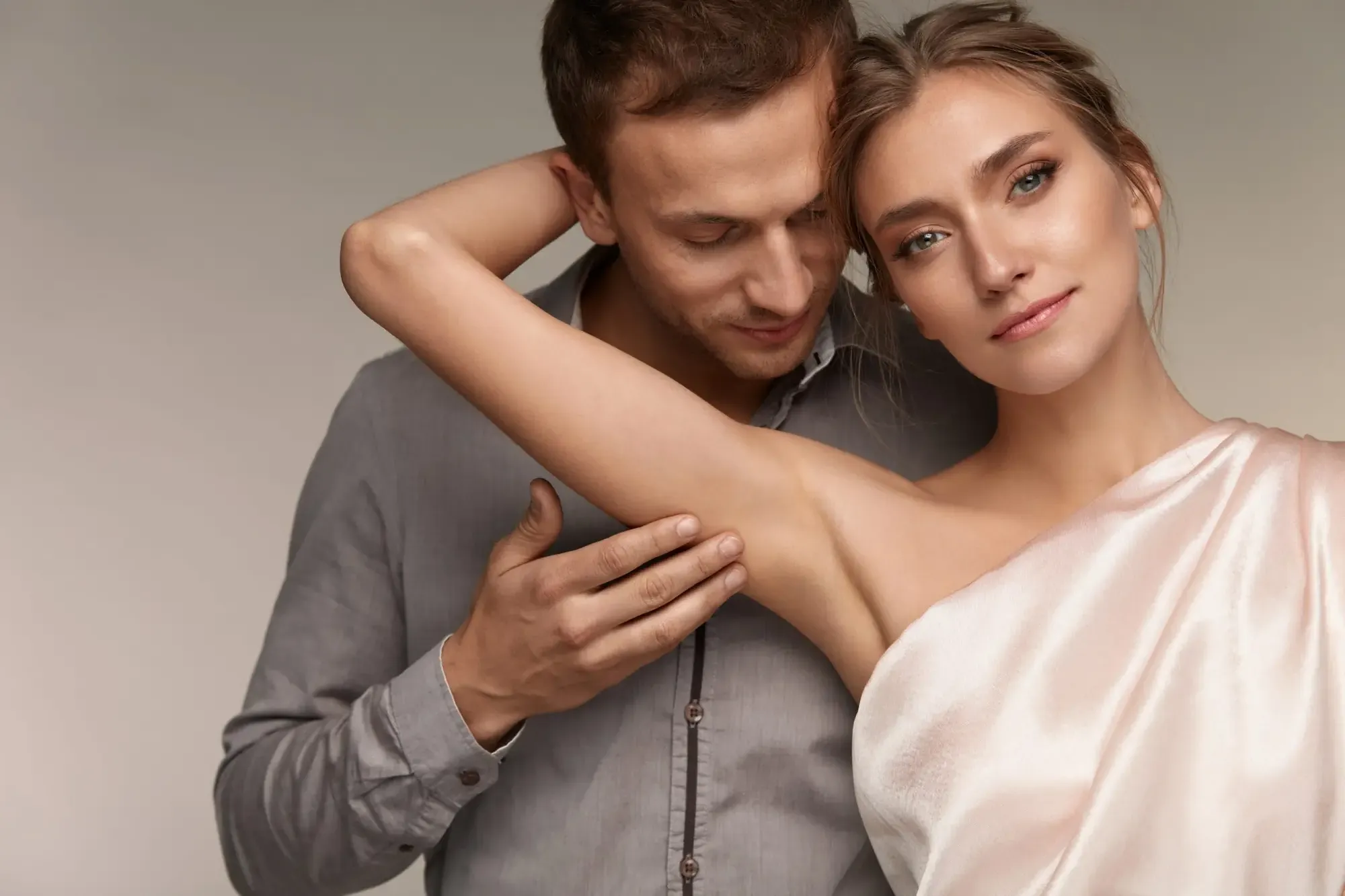 Couple with soft, healthy skin embracing